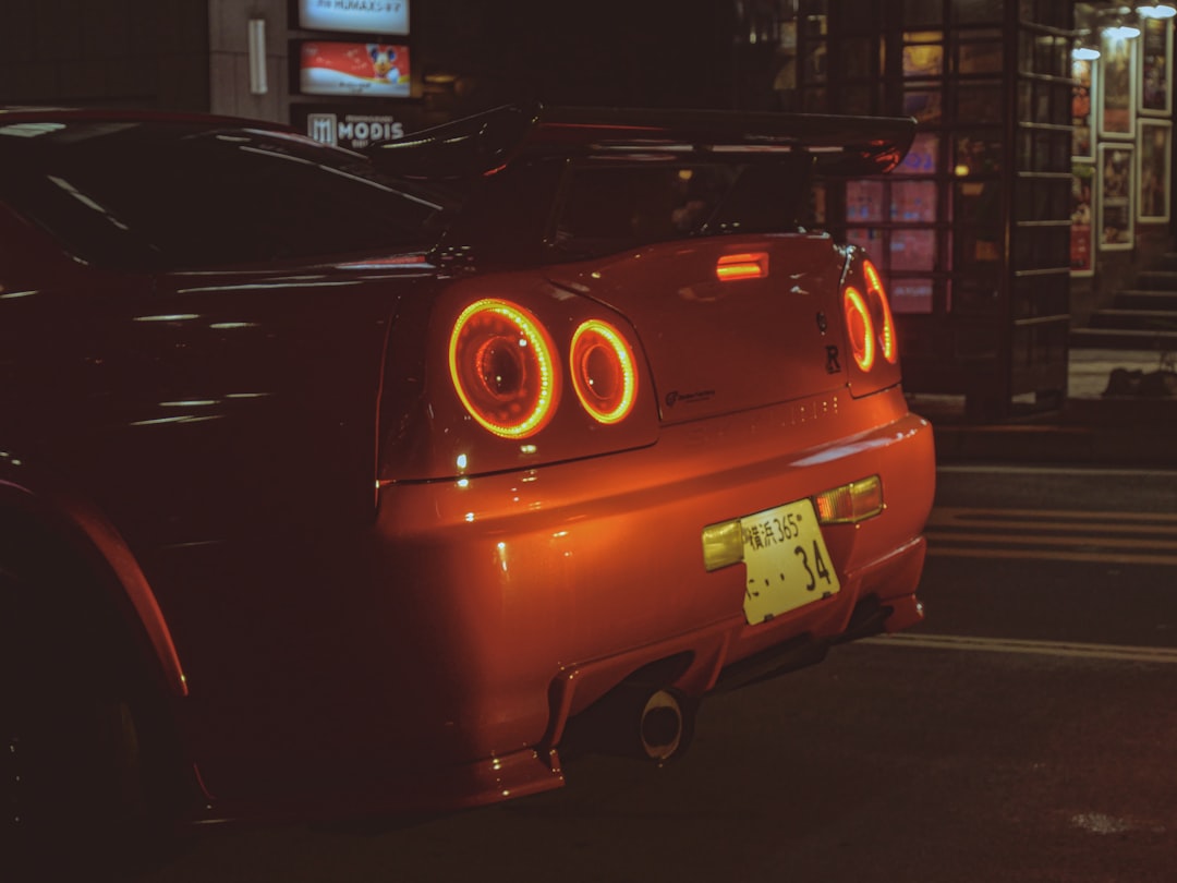 Red sports car taillights glowing at night