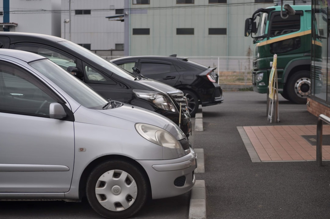 a couple of cars parked next to each other in a parking lot