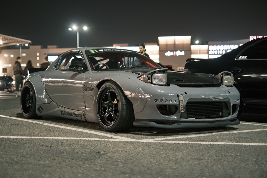 A silver sports car parked in a parking lot